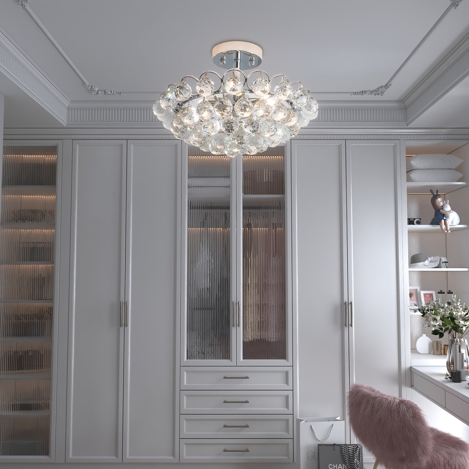 Crystal bubble light fixture mounted on ceiling above built-in white wardrobes and shelves with soft ambient lighting