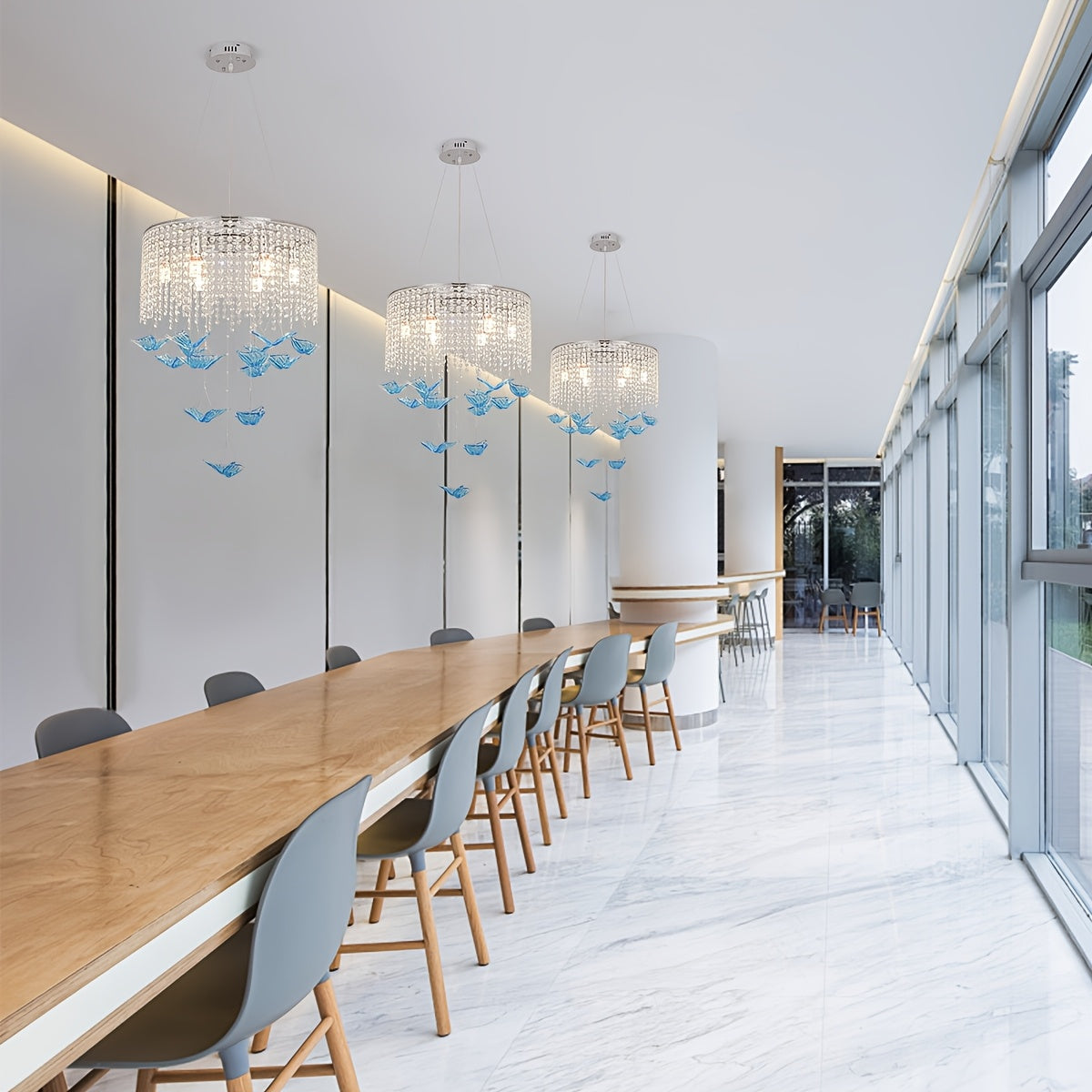 Long seating area with 3 butterfly light fixtures featuring crystal strands and blue hanging butterflies suspended from the ceiling