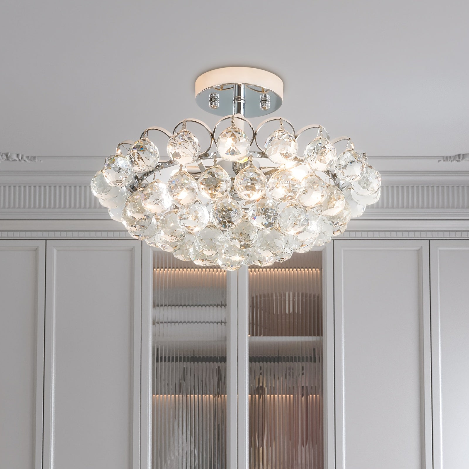 Mounted on the ceiling, this lighting piece showcases soft illumination through sparkling glass droplets in a close-up view