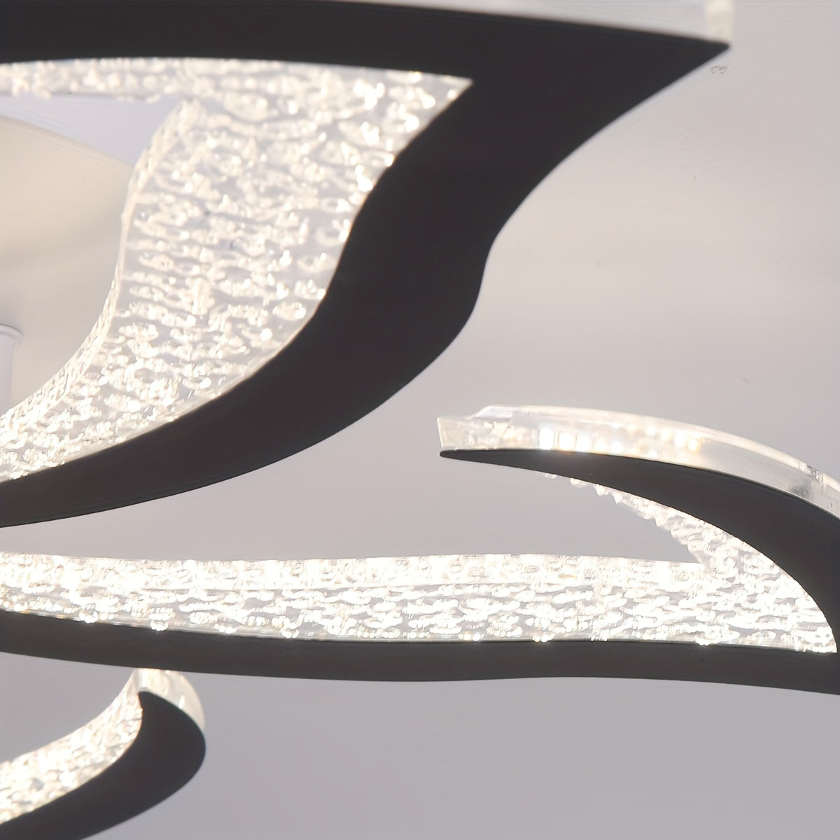 Detailed view of textured acrylic light panels with integrated LEDs, showcasing curved edges and bright, diffused illumination