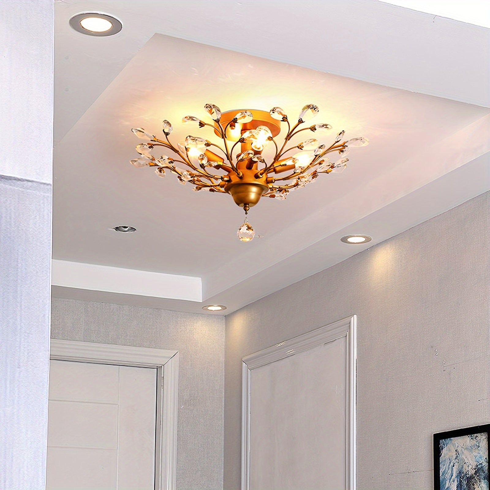 Gold vintage ceiling light fixture with crystal branches mounted on a recessed ceiling section