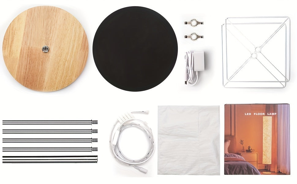 Various components of a modern floor lamp laid out for assembly, including its base, frame, and electrical parts