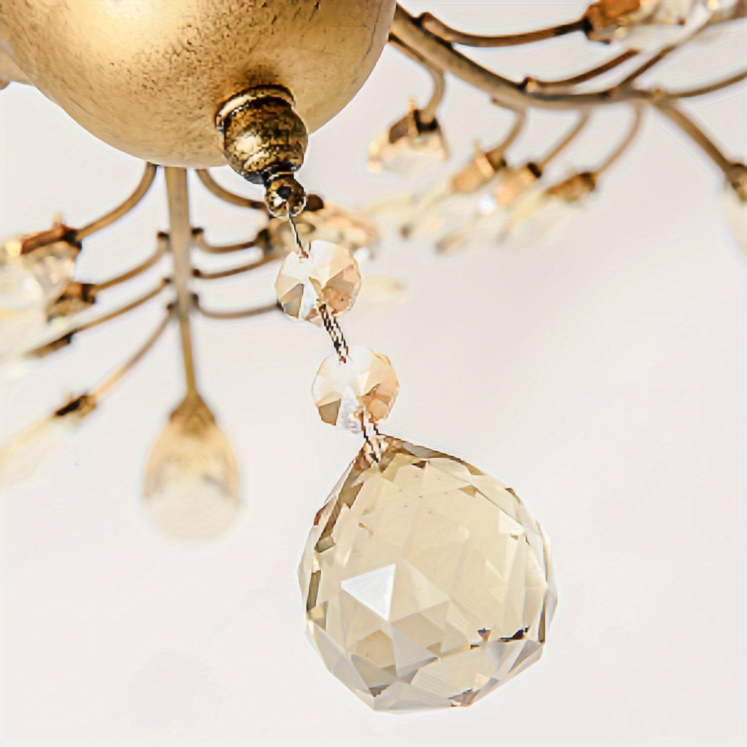 Vintage ceiling light with a gold finish and a hanging crystal drop, adding a classic and stylish touch to the room