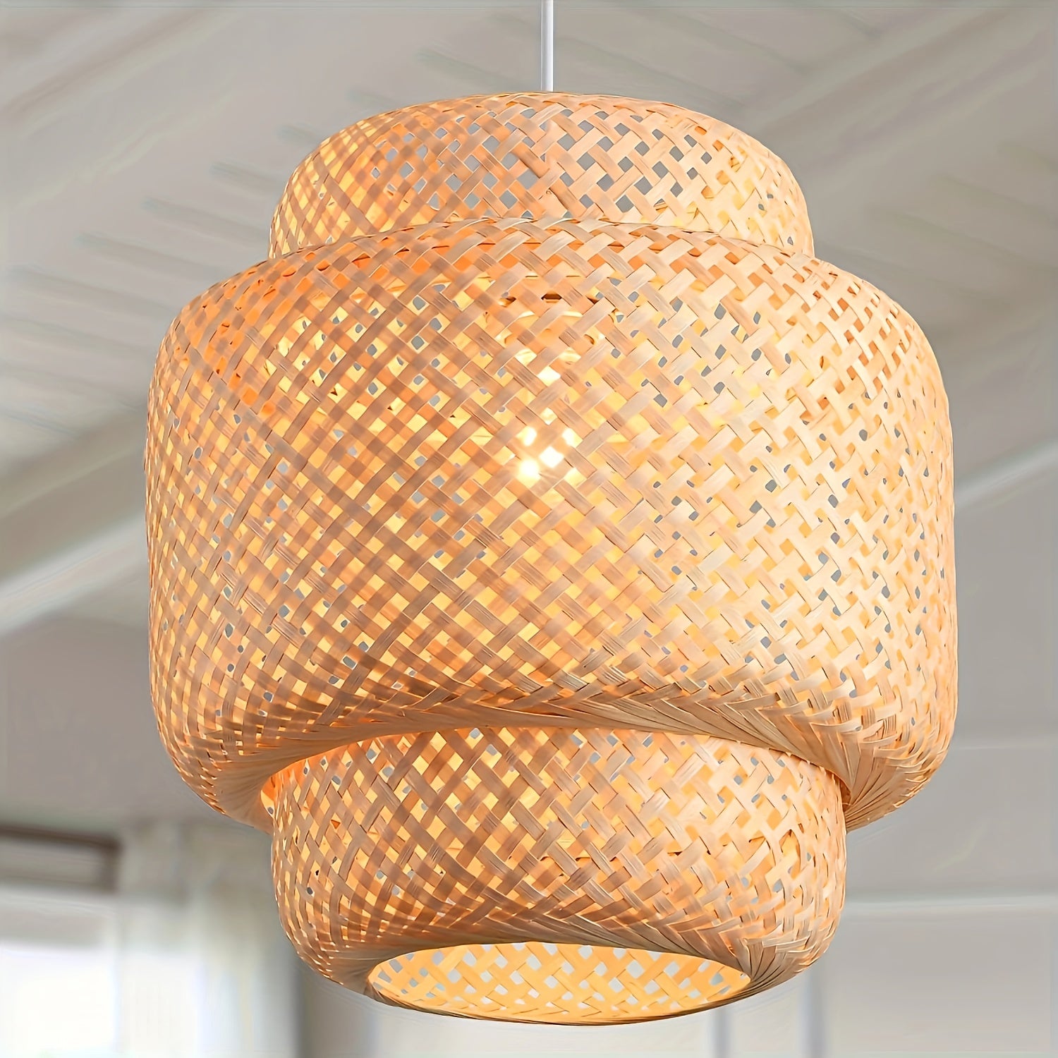 Detailed hanging view showing the woven shade design and warm glow of a natural pendant finished with a rattan ceiling light fixture