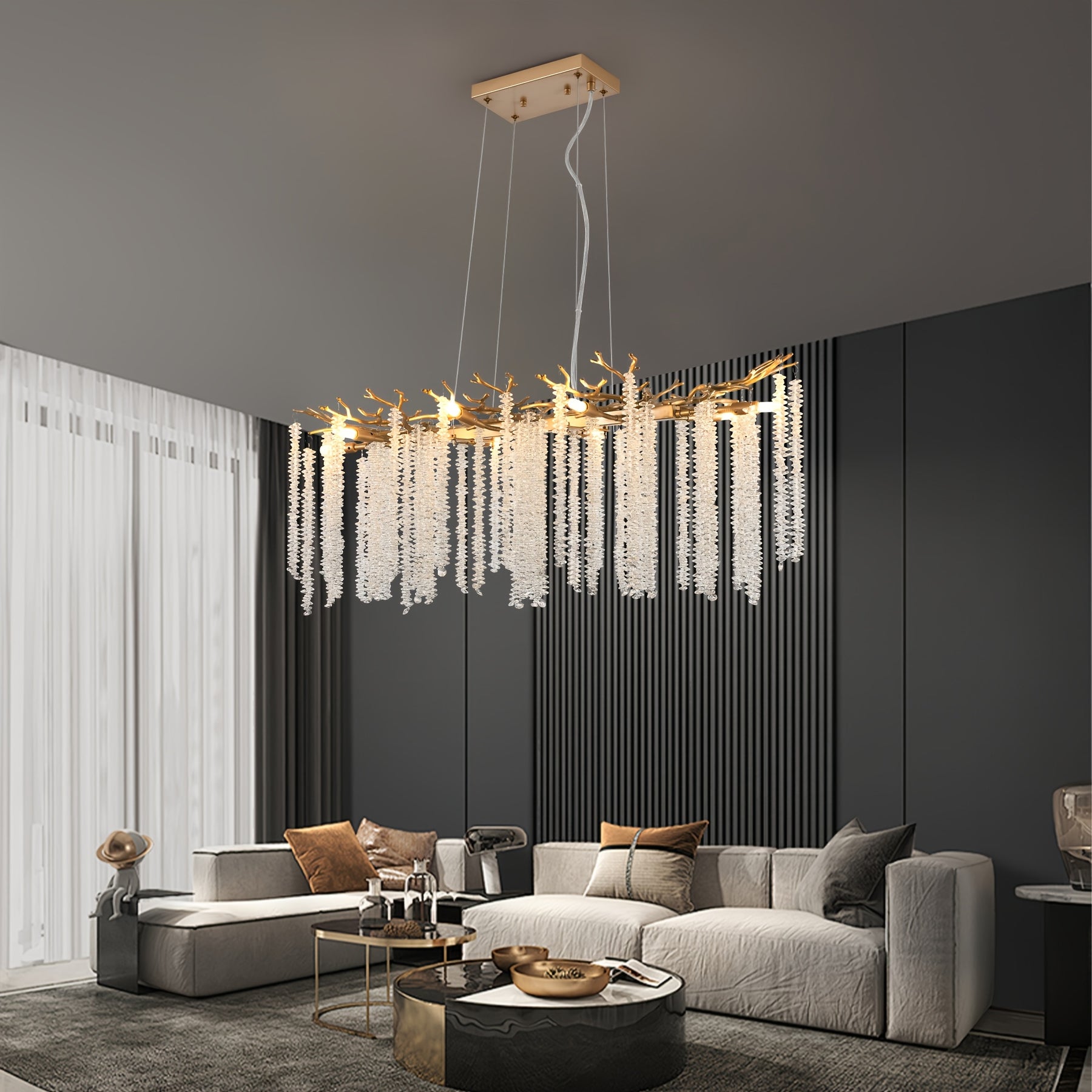 Stylish interior with dark walls and neutral furniture, highlighted by a gold branch chandelier with cascading crystal strands