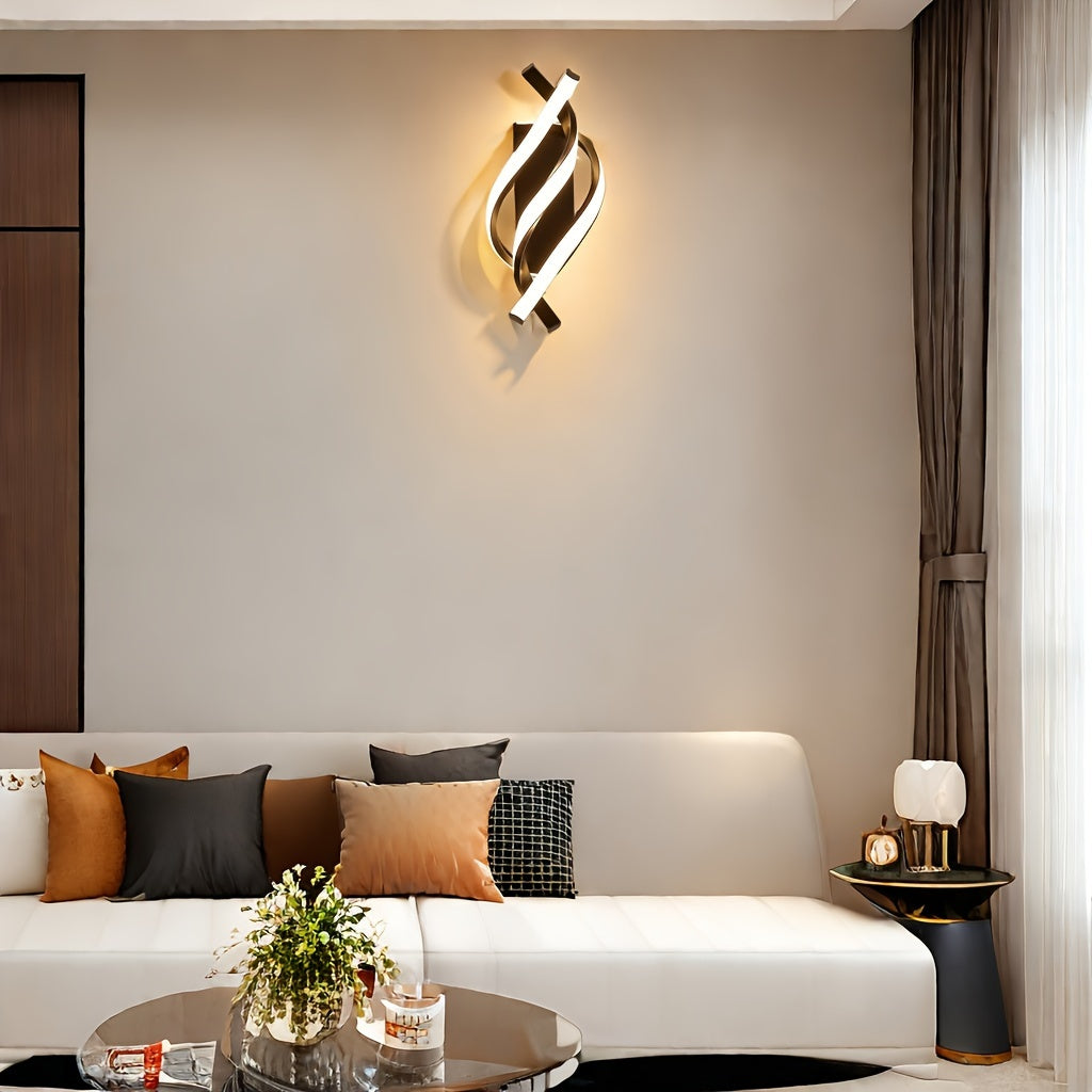 Soft ambient glow fills the space with a gold-finished fixture featuring a curved LED wall sconce above a modern white couch