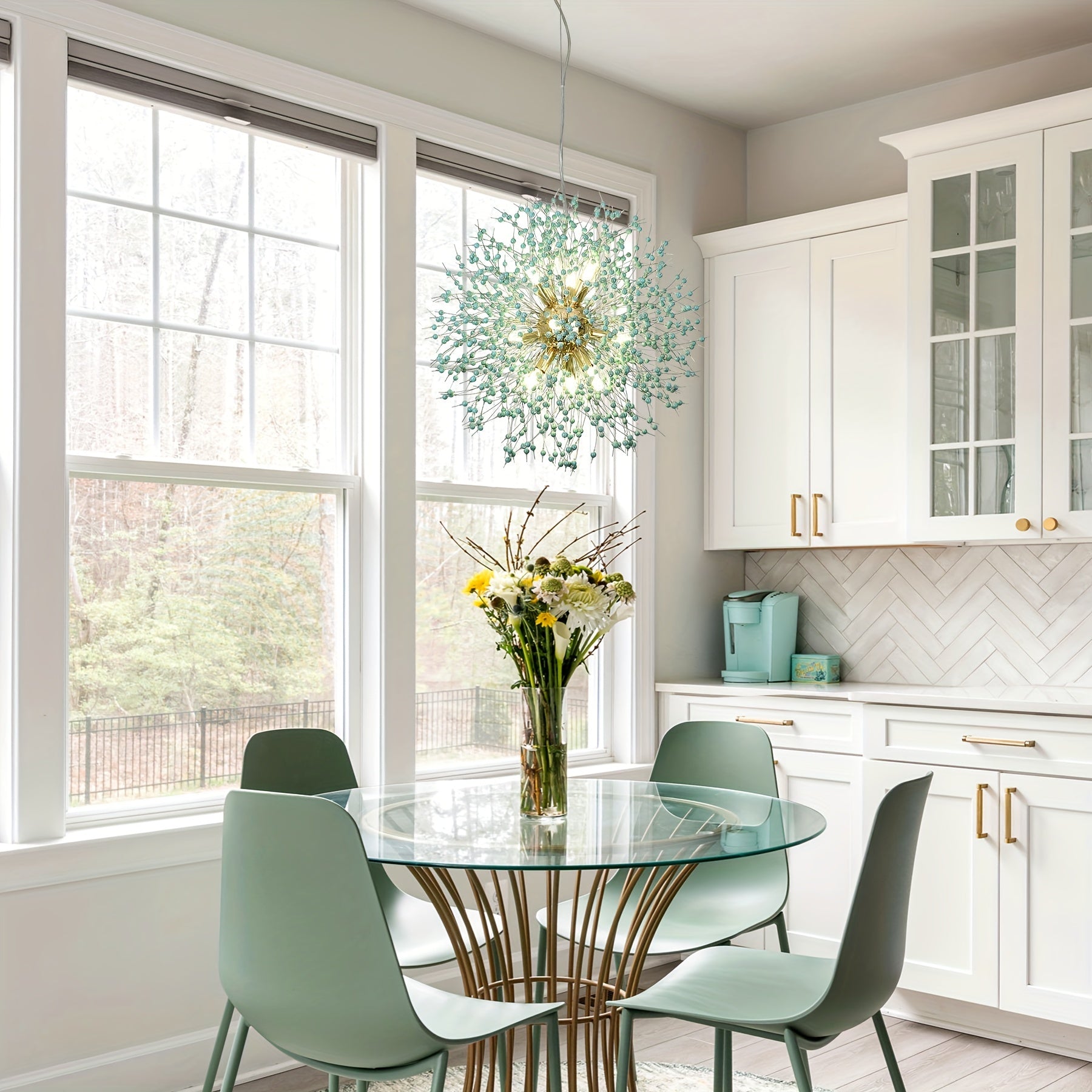 Unique dandelion-inspired chandelier with light green elements, illuminating a modern kitchen dining area with a glass table and chairs