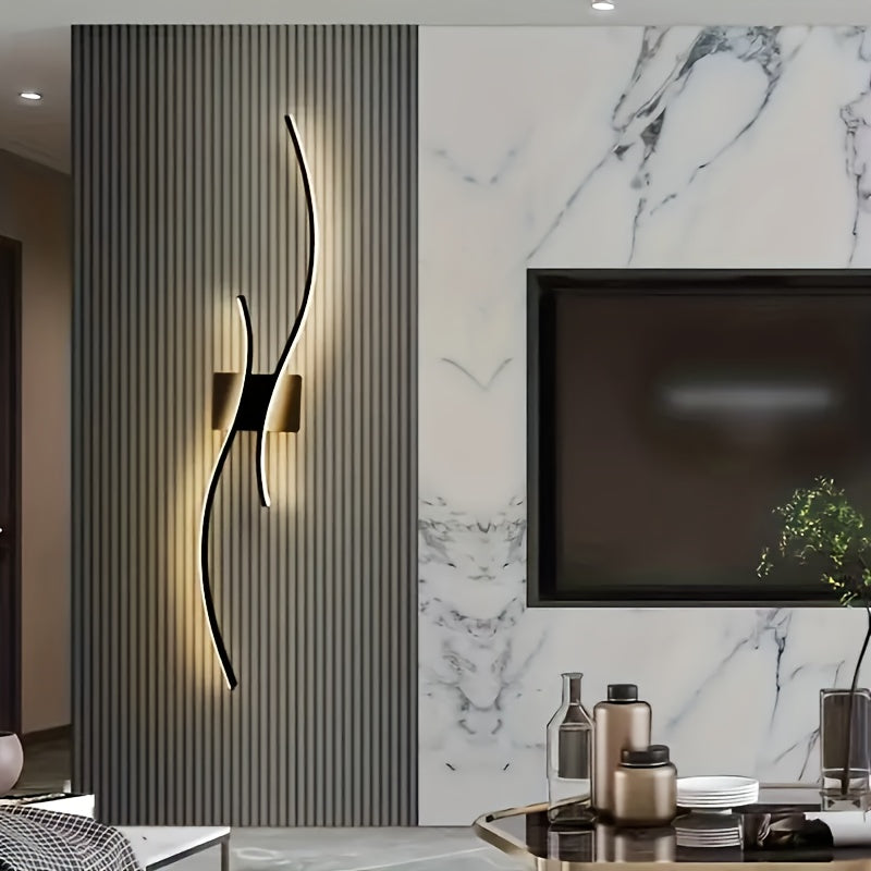 Living room accent wall featuring a curved contemporary LED wall light mounted on a vertical panel
