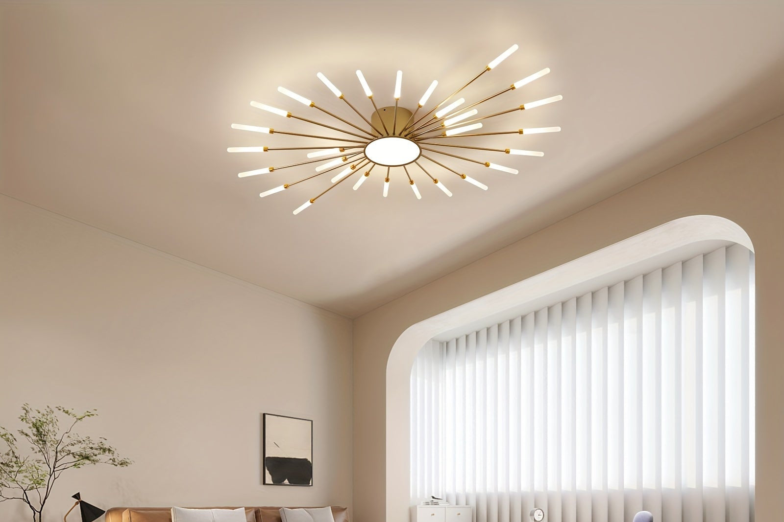 A gold sputnik flush mount ceiling light installed in a contemporary space with neutral walls, arched window, and a cozy seating area