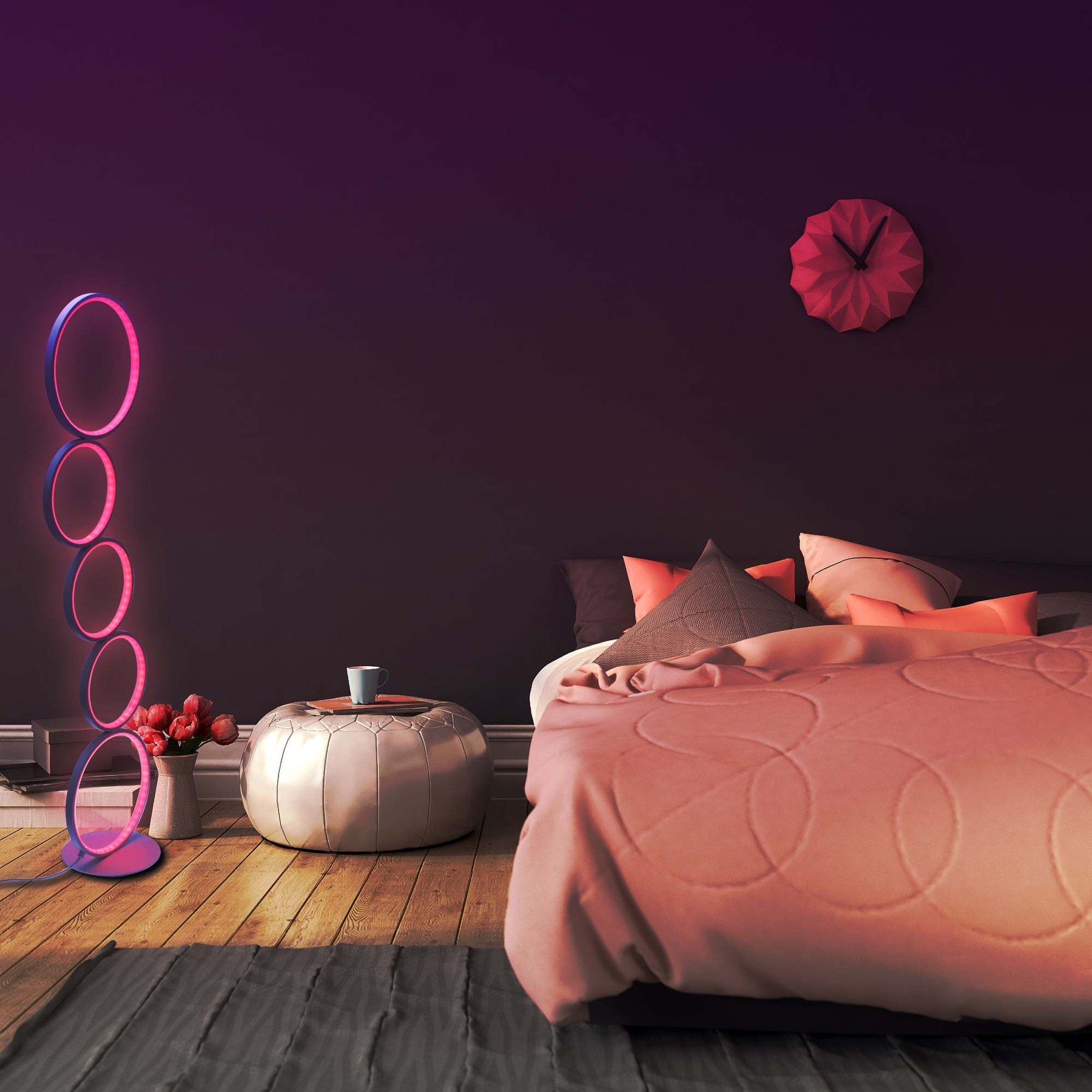 Cozy bedroom scene featuring an RGB circular floor lamp with pink glowing rings, placed beside a low stool and flower vase on a wooden floor