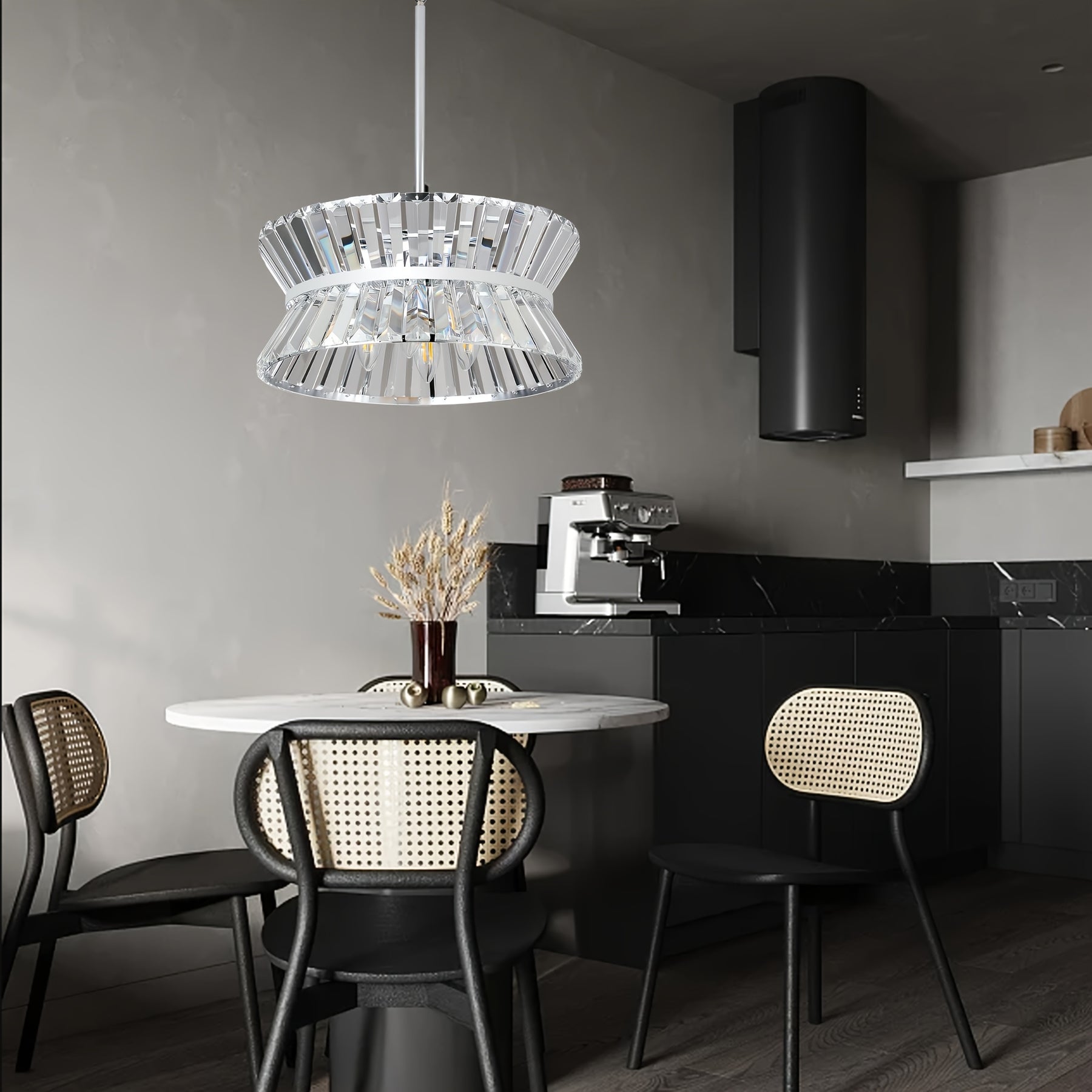 Semi flush crystal chandelier hanging above a modern dining area with black cabinets and rattan chairs, adding a luxurious touch to minimalist kitchen decor
