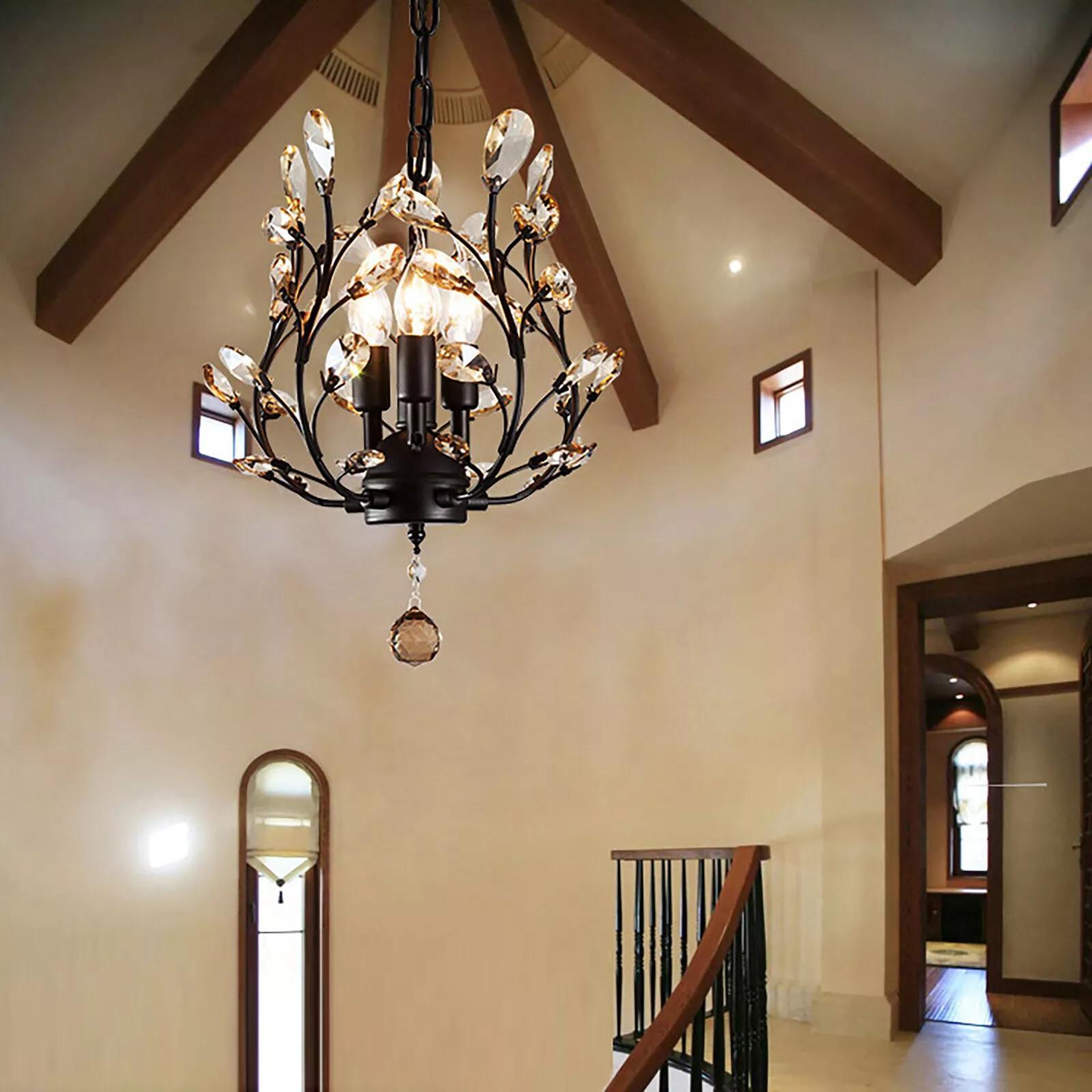 Placed above a stair landing, this light belongs to small modern chandeliers and blends well with wood beams and soft wall tones