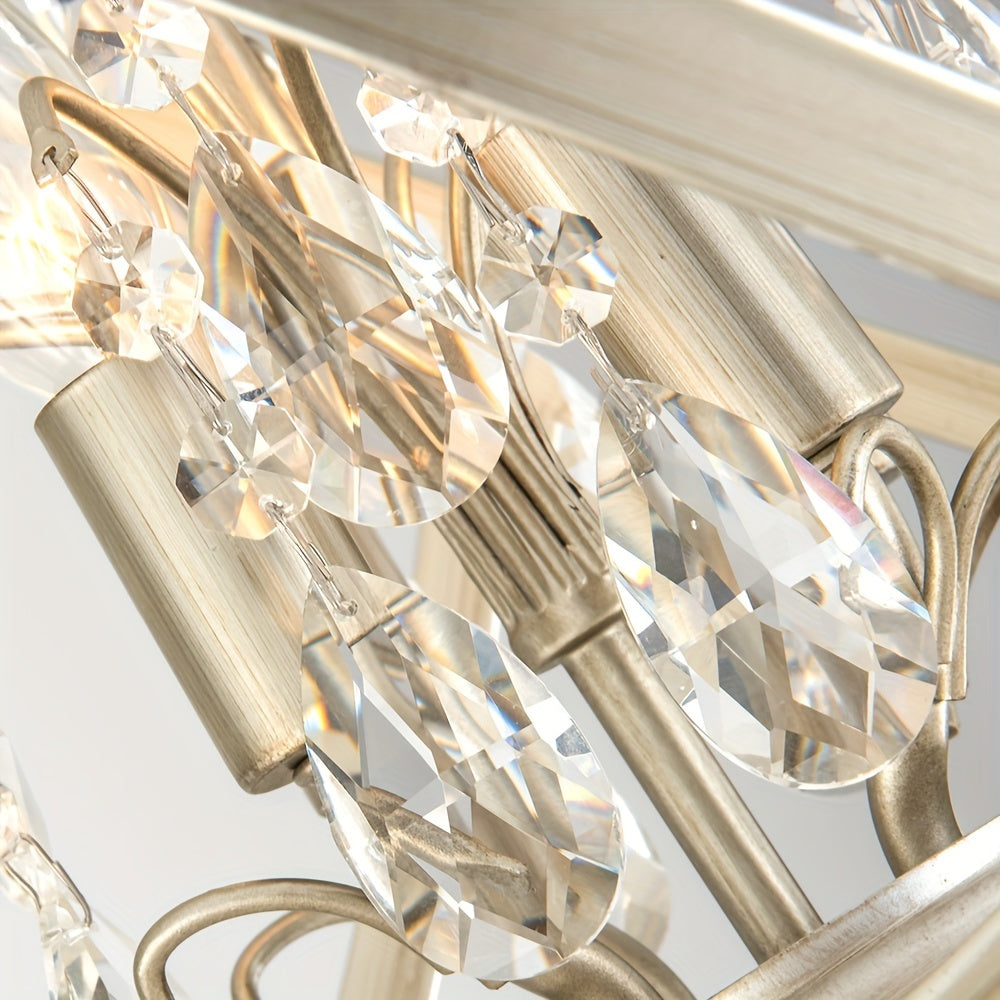 Hanging teardrop crystals featured on a gold chandelier, showcasing precision-cut details and reflective sparkle