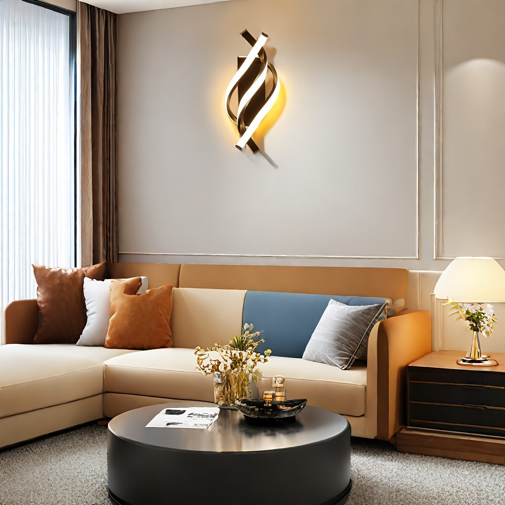 Modern wall-mounted sconce with a twisted LED design glowing warmly above a neutral sofa in a cozy living room setting