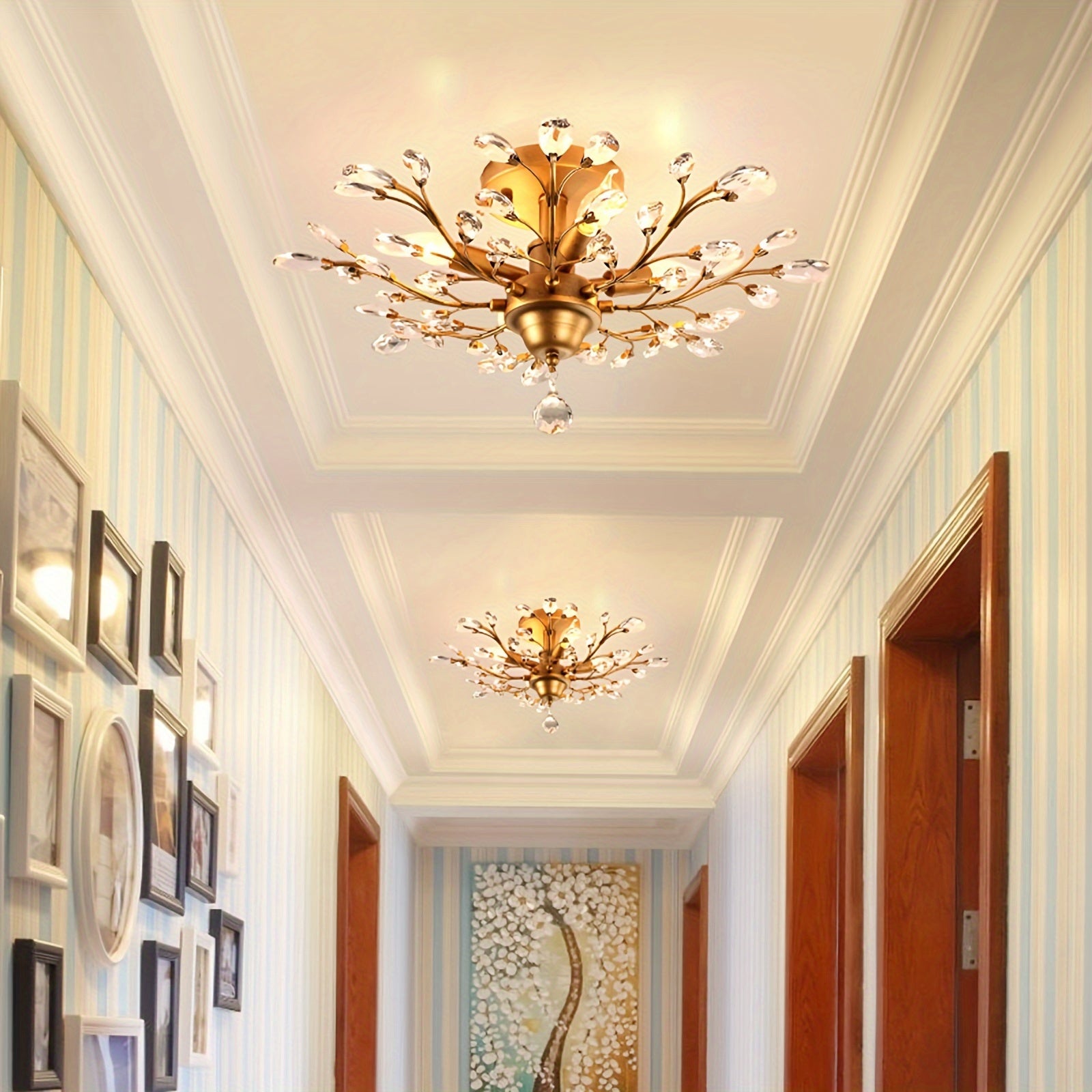Stylish hallway illuminated by two matching vintage ceiling light fixtures with gold finish and crystal accents on a decorative tray ceiling