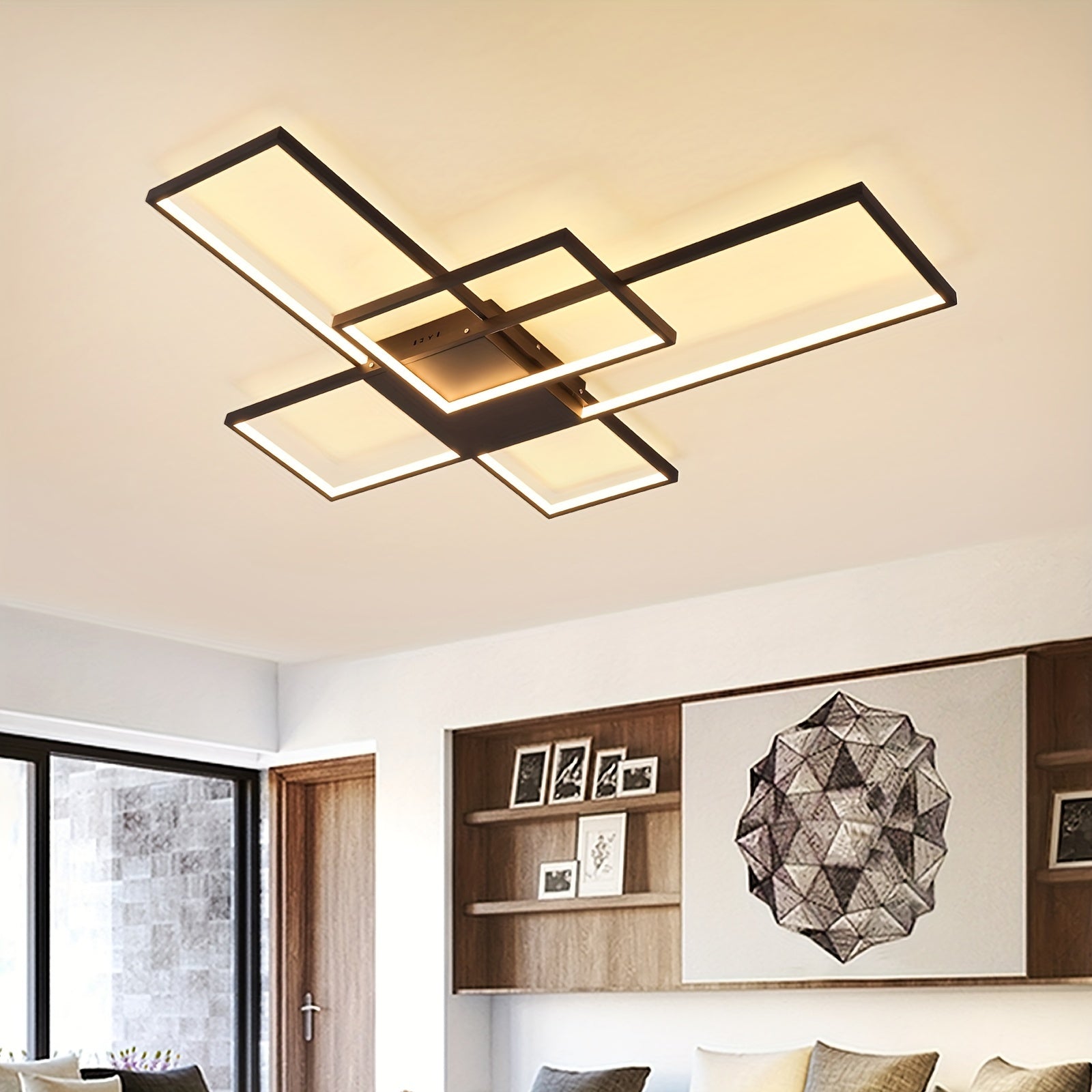 Interior room with a black-framed LED ceiling light emitting warm white light, surrounded by neutral walls, wooden shelves, and earthy-toned decor