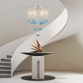 Sculptural centerpiece beneath a spiral staircase, illuminated by a butterfly crystal light suspended from the ceiling