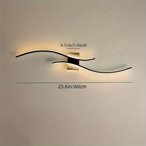 Contemporary LED wall light with dual curved arms mounted on a square base, shown with width and depth dimensions labeled in inches and centimeters