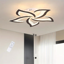Black-trimmed flower-shaped LED ceiling light illuminating a minimalist space with white curtains and a vertical black wall feature