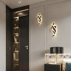 Soft ambient glow from a pair of curved LED wall sconces mounted beside built-in shelving and a modern side table