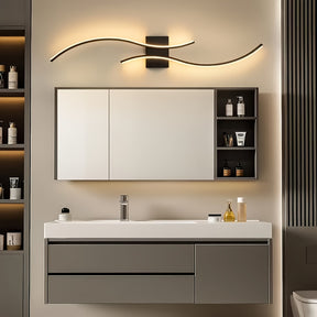 Mirror cabinet setup highlighted by a wave-shaped LED wall light mounted above, casting a soft ambient glow