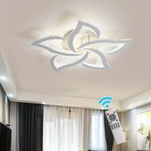 Contemporary LED fixture with petal-shaped acrylic panels and ambient glow, installed in a softly lit interior accented by sheer curtains