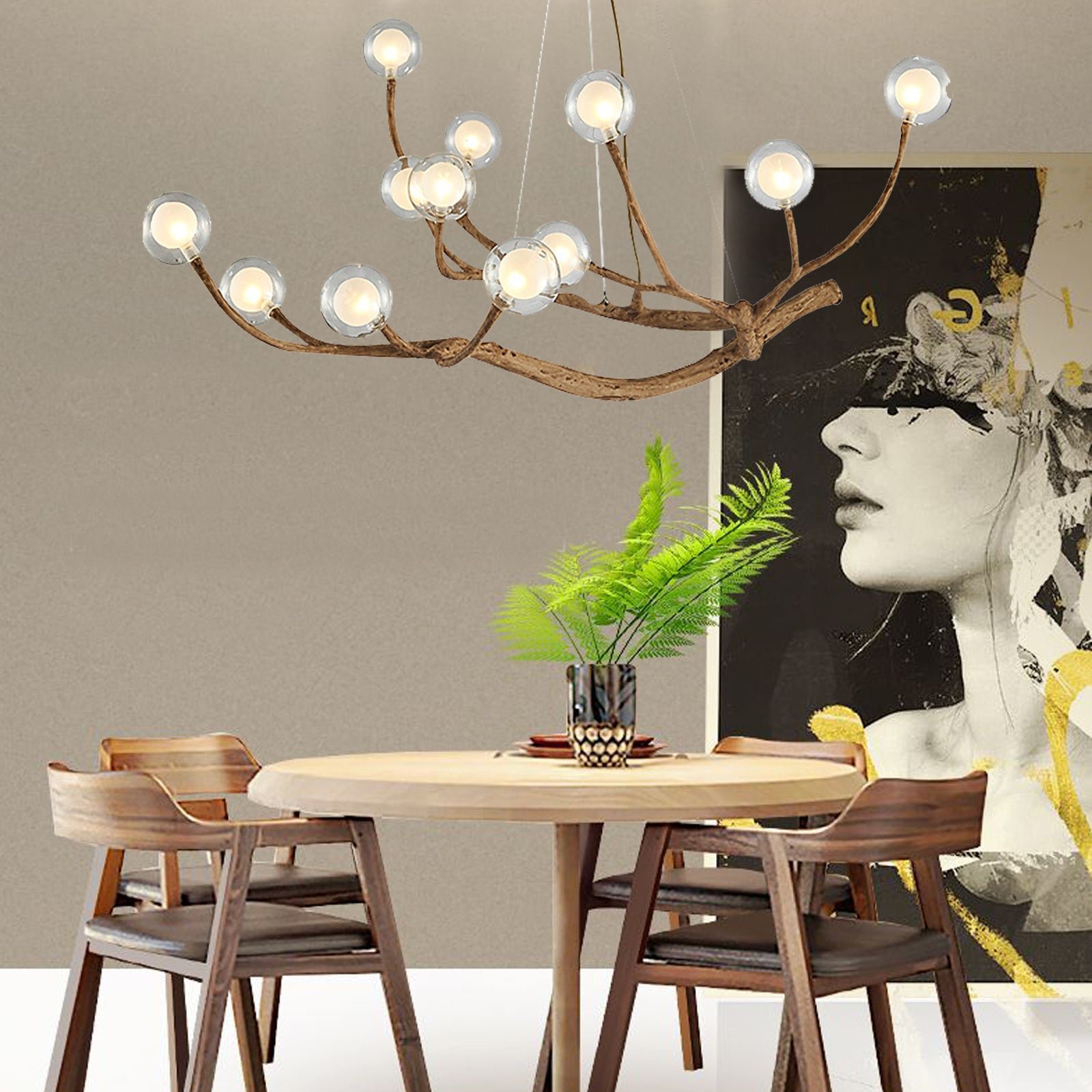 Chandelier with curved wooden branches and glowing glass globes, hanging above a round dining table with wooden chairs and modern wall art
