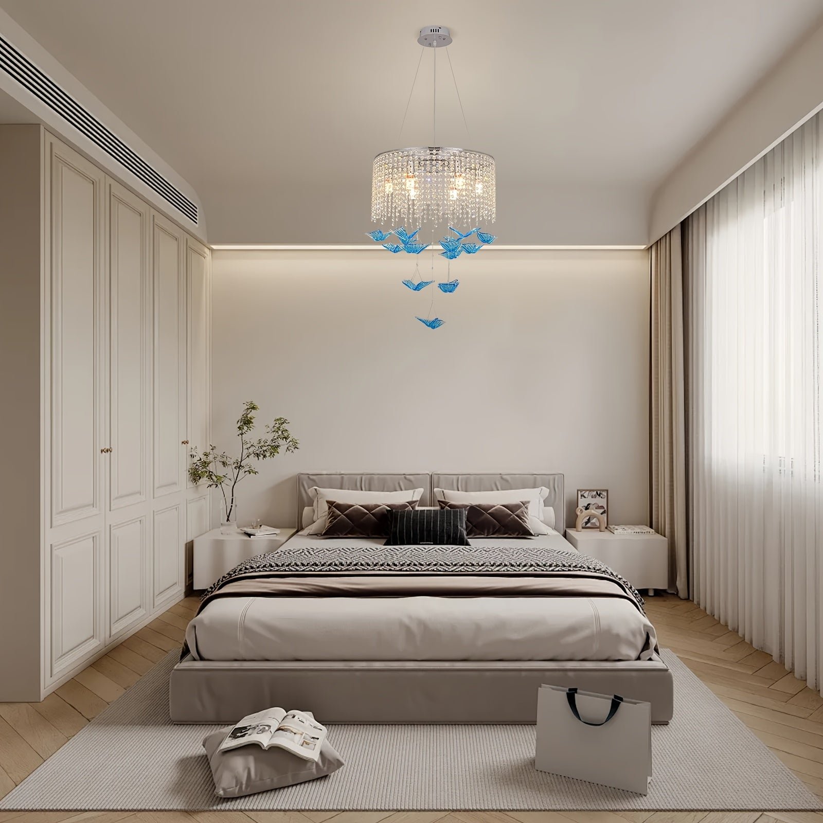 Bedroom setup with soft lighting, featuring a butterfly light fixture with crystal strands and blue butterfly pendants suspended from the ceiling