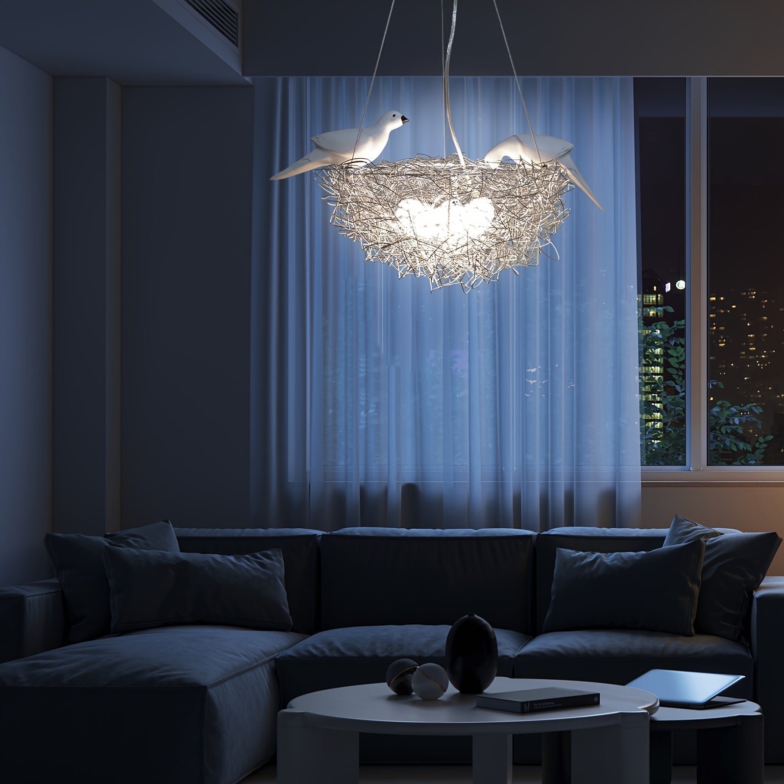 Nest-shaped pendant light with bird accents glowing brightly in a softly lit indoor setting with curtains and nighttime window view
