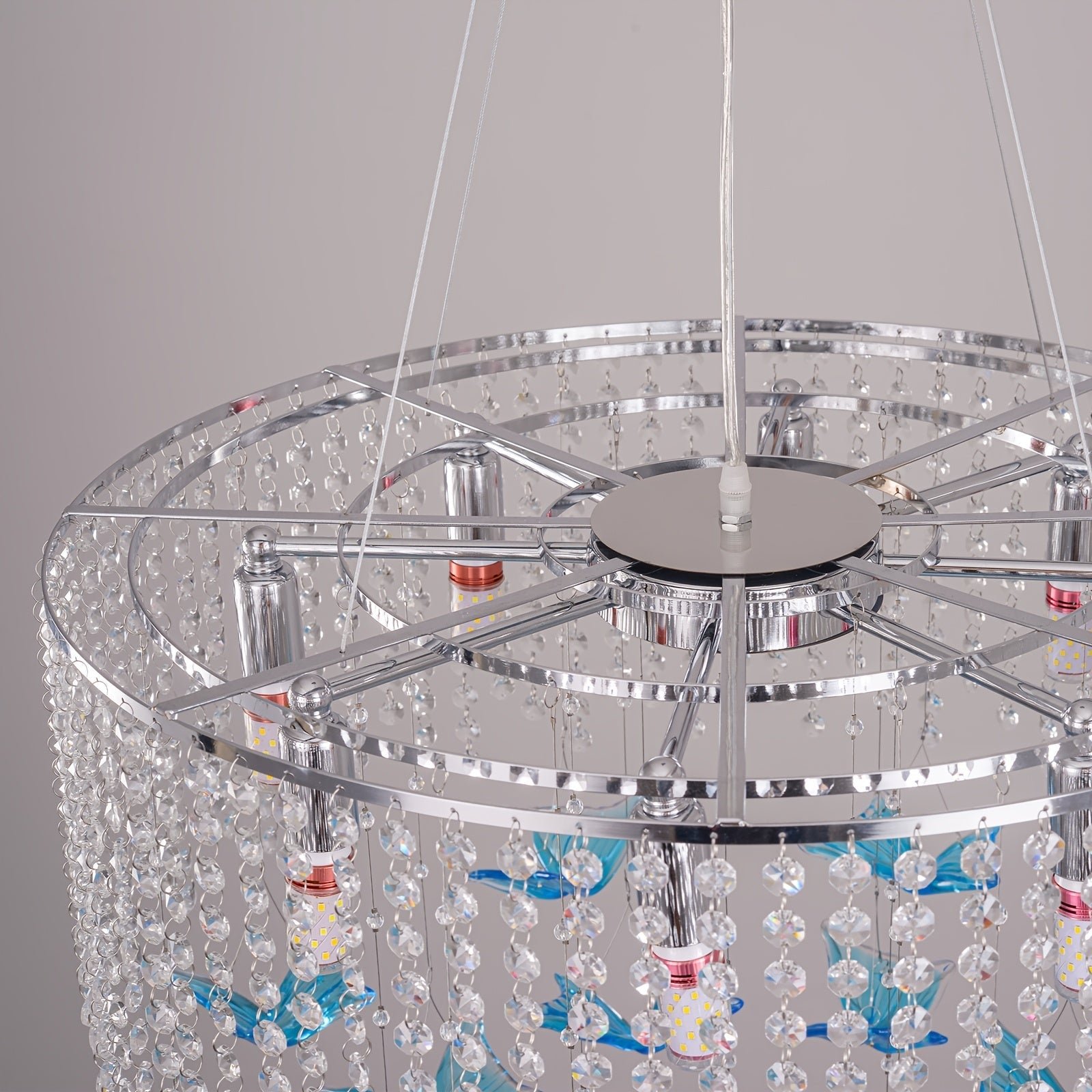 Polished metal frame chandelier featuring K9 crystal bead strands, multiple E12 bulb sockets, and hanging blue glass accents