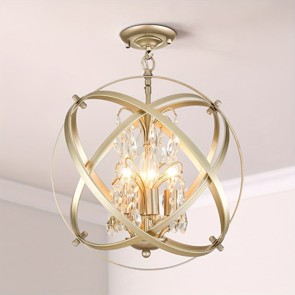 Gold chandelier with a crystal globe design, intersecting metal bands, and hanging crystals around candle-style bulbs