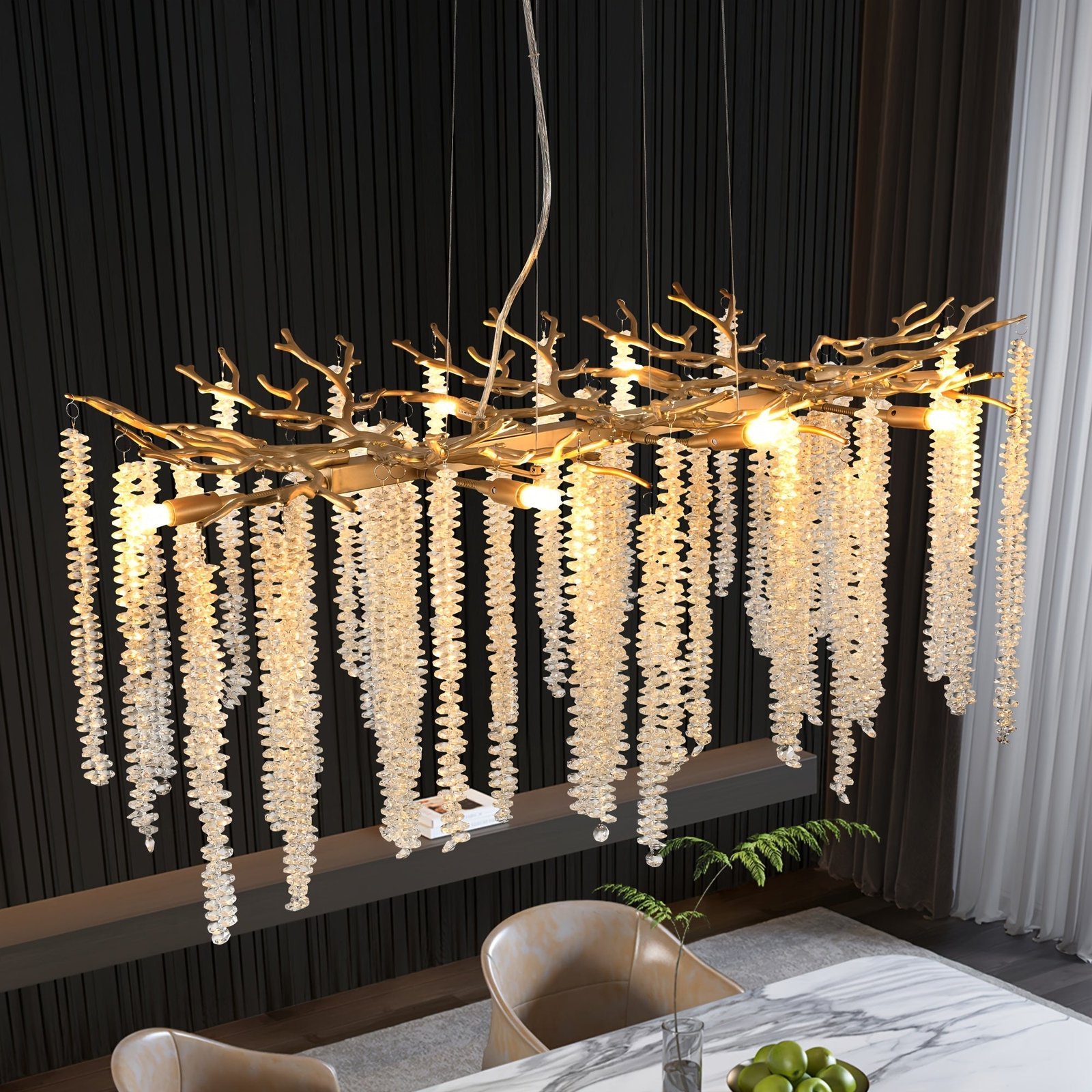 Statement gold chandelier with cascading crystal strands and artistic branch design, creating a dramatic focal point above a modern dining table