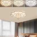 Petal-inspired LED ceiling light with crystal drops, shown in a bedroom with soft lighting and multiple brightness tones