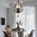 Hanging above a round dining table, this small modern chandelier with crystal-tipped branches adds a stylish touch