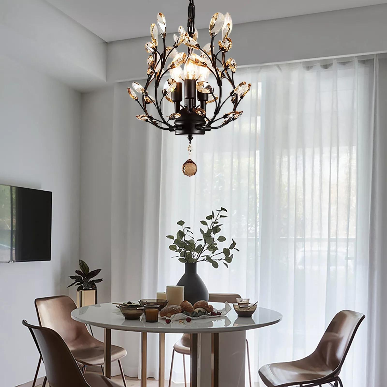 Hanging above a round dining table, this small modern chandelier with crystal-tipped branches adds a stylish touch